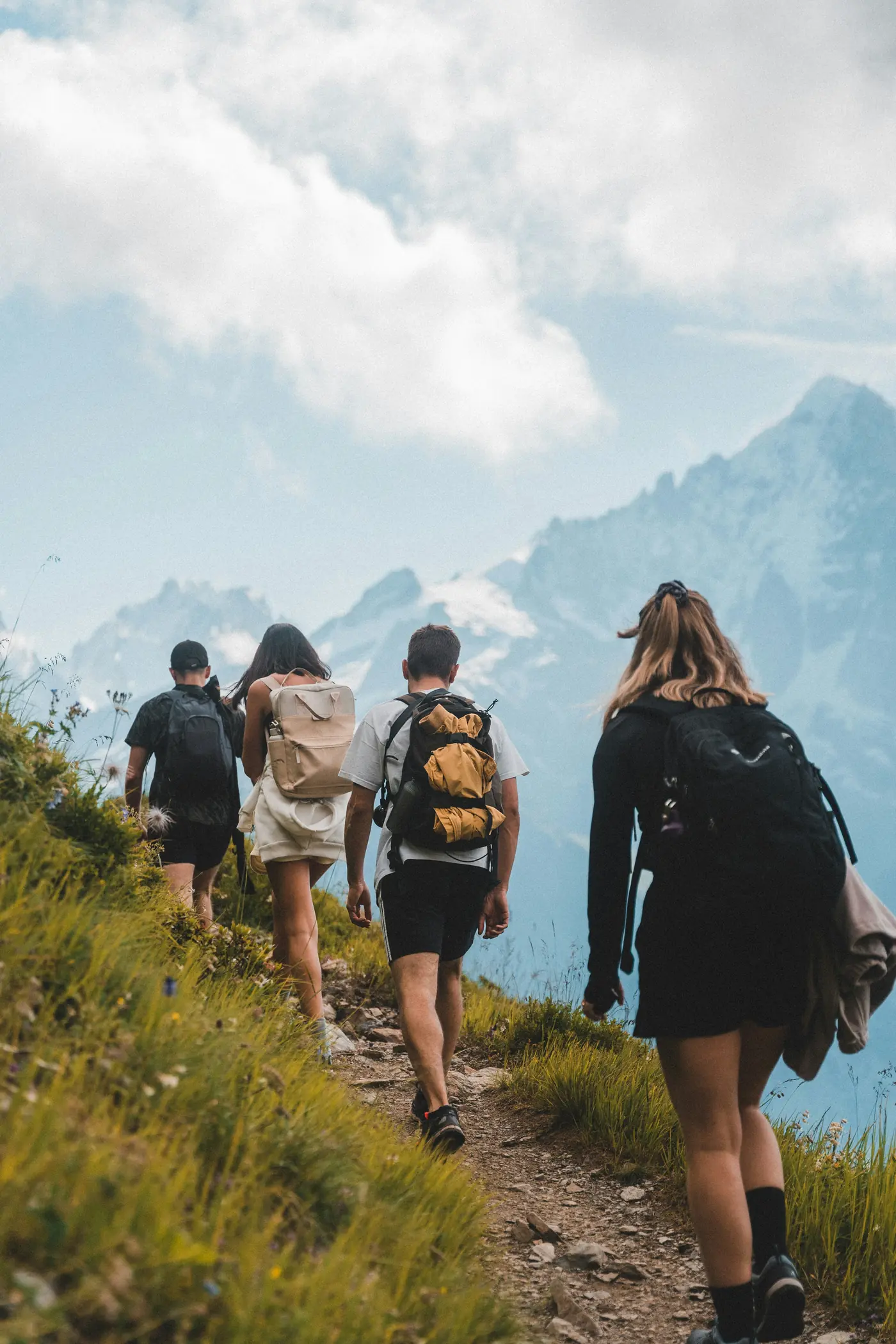 Teenagers hiking together along a mountain trail