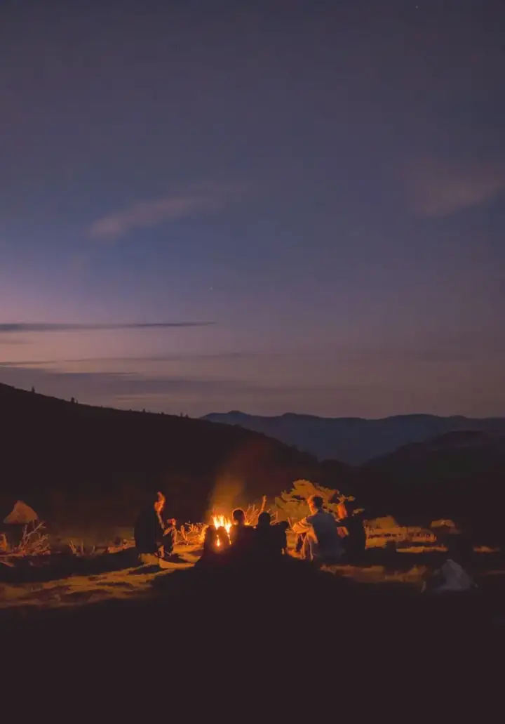 Campfire glowing at twilight in the Australian bush