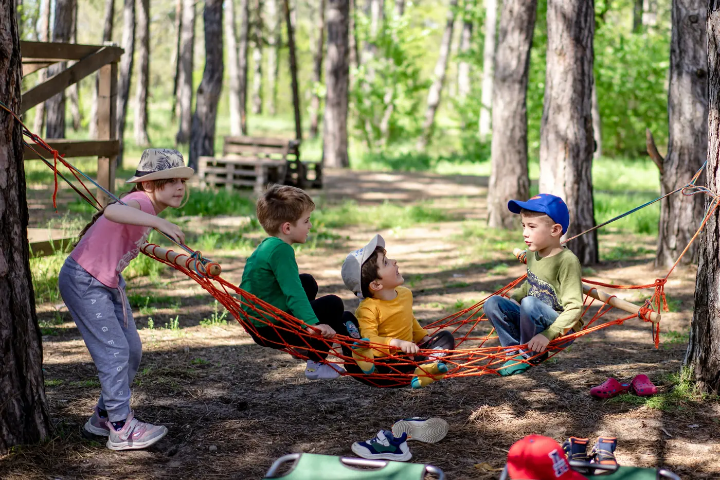 Young children playing and crafting at an outdoor camp